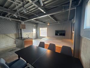 a conference room with a black table and chairs at 5名様まで宿泊可能 四万十市下田の一棟貸し宿 明の宿 akari in Shimanto