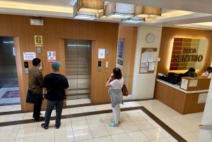 a group of people standing in a lobby at NagaCityRiverView 2BR Apartment in Naga