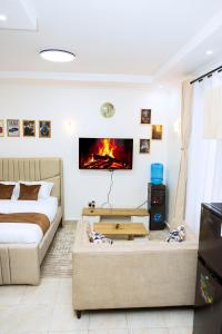 a living room with a bed and a couch at Epitome Luxe Homes near UN Gigiri and Two Rivers Mall in Ruaka