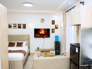 a living room with a bed and a couch at Epitome Luxe Homes near UN Gigiri and Two Rivers Mall in Ruaka