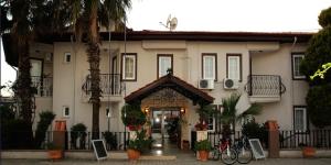 a large white building with a doorway in front at So Dalyan in Ortaca