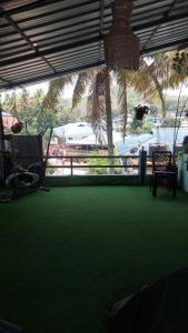 a green carpeted room with a view of a train at mountainview homestay in Jāmb