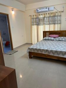 a bedroom with a bed in a room at Krishna vykundam guruvayur in Guruvāyūr