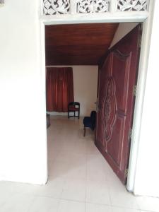 an open room with a red door and a chair at NS Apartments in Dalugama
