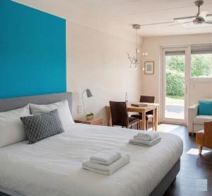 a bedroom with a large bed with towels on it at Rheezerstee in Rheeze