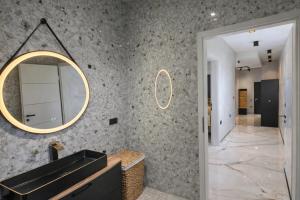a bathroom with a sink and a mirror at DINLUX Luxury Apartment in Maribor +17 photos