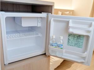 an open refrigerator with two bottles of water in it at muniyuitsu 宮古島 spa&park in Miyako-jima