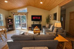 a living room with couches and a fireplace at River Song Cabin home in Leavenworth