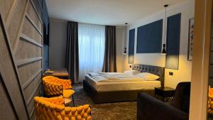 a hotel room with a bed and a couch at Pensiunea SOLEA in Ucea de Jos +44 photos