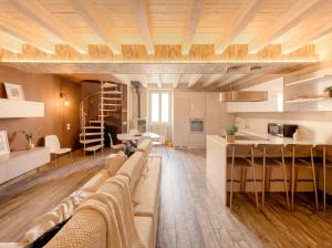 a living room with a couch and a table and a kitchen at Iseo Lake Luxury Duplex - Centro & Design in Iseo