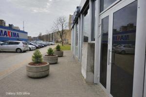 a street with cars parked in a parking lot at D20 apartamentai in Mažeikiai