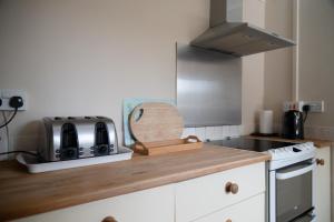 a kitchen with a counter with a toaster and a sink at The Studio in Somerton