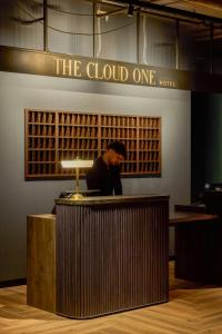 a man standing behind a counter in a wine store at The Cloud One Frankfurt-Metropolitan in Frankfurt