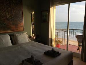 a bedroom with a bed with a view of the ocean at Sitges Beach Panorama in Sitges