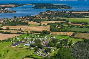 an aerial view of a farm with a lake at Glamping, Tåsinge - Svendborg in Svendborg