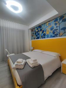 a bedroom with a large bed with towels on it at Yellow Dream B&B 2 in Torre Melissa