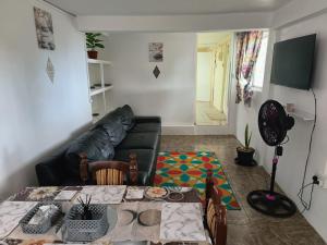 a living room with a couch and a table at Ocean View Guest Apt in Kingstown