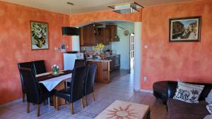 a kitchen and dining room with a table and chairs at Relax Apartman Gyula in Gyula