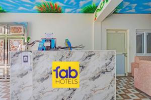 a sign on top of a counter with aida hotels sign on it at FabHotel Ultra Stay in Bhubaneshwar +25 photos