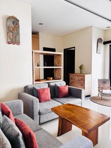 a living room with a couch and a coffee table at Villa Reisya in Nusa Dua