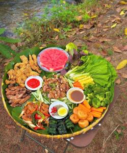 a plate of food with different types of food on it at Healing Space Bungallow Bao Loc in Bảo Lộc