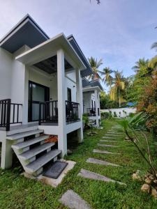 a house with stairs leading to the front of it at Nua Tone Riverside in Thalang