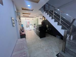 a hallway with a staircase in a house at Hotel Grand Father in Agra