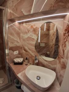 a bathroom with a sink and a mirror at Hotel Fiori in Rome +39 photos