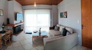 a living room with a couch and a table at STUDIO WITH SEA VIEW - KYPARISSIA beach in Kyparissia