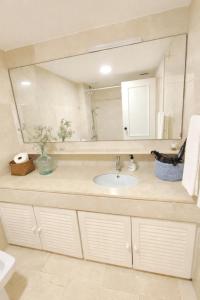 a bathroom with a sink and a large mirror at Estudio Puerto de Sotogrande in Sotogrande +18 photos