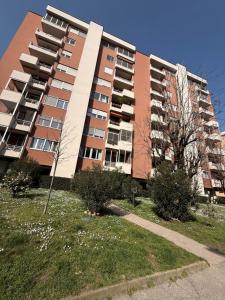 a large apartment building with trees in front of it at Casetta Cortese in Opera