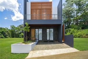 a house with a view of the yard at Redbrick Villa By The Feelas in Bandung