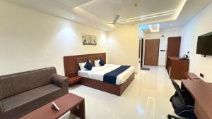 a hotel room with a bed and a couch at Hotel Parv Vilas in Behror
