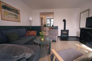 a living room with a couch and a table at Vila Krocinka in Prague