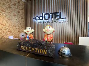a table with a cake on top of it at RedDoorz Plus at edOtel Malang in Betek