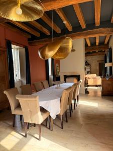 a dining room with a large table and chairs at Chez collette in Chablis