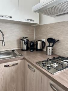 a kitchen counter with pots and pans on a stove at Easy Bergamo Apartment in Bergamo