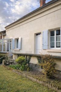 a house with a white door and a window at Maison de la Vallée - proche Zoo Beauval in Angé +8 photos
