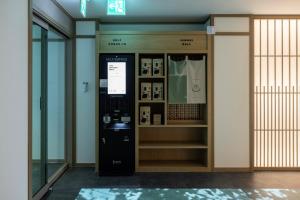 an atm machine in a room next to a door at Anook Ryokan Hotel Daejeon Daeheung in Daejeon