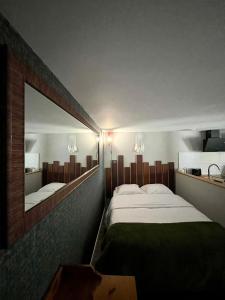 a bedroom with a large bed and a large mirror at Appartement confortable et accessible in Pelves
