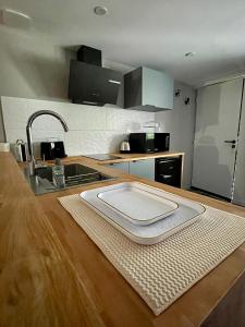 a kitchen with a sink and a counter top at Appartement confortable et accessible in Pelves +14 photos