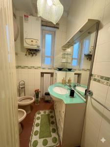 a bathroom with a sink and a toilet and a mirror at ADAapartmenthousesalerno in Salerno +9 photos