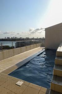 a swimming pool on the side of a building at C Waves Palm Terraces in Mombasa +15 photos