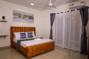 a bedroom with a bed and a window at C Waves Palm Terraces in Mombasa