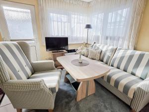 a living room with a couch and two chairs and a table at Stettiner Str 6c in Grömitz