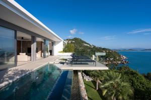 an external view of a house with a swimming pool at Sukkho Samui Estates in Chaweng Noi Beach