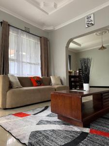 a living room with a couch and a coffee table at Olive homes in Nkunjila