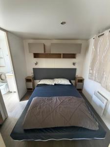 a bedroom with a large bed in a room at Camping le Neptune in Argelès-sur-Mer