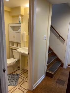a bathroom with a toilet and a sink at Flower Avenue Hosting -Two DB Beds & Shower - Ground Floor Bedroom 1 Person 66 Night, 2 persons 122 - 3rd & 4th add 52 each in Silver Spring +13 photos