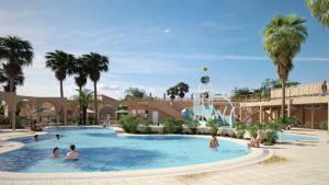 a group of people in a swimming pool at a resort at Camping le Neptune in Argelès-sur-Mer +10 photos